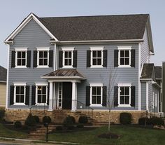 a blue house with white trim and black shutters