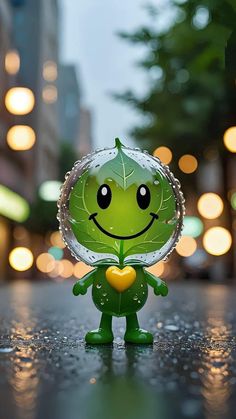 a little green toy with a heart on it's chest and eyes are standing in the rain