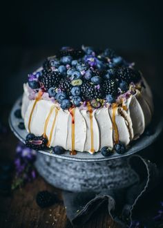 a cake covered in blueberries and other toppings