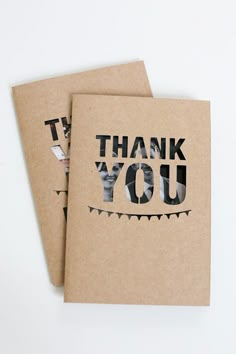 two thank cards with the words thank you printed on them, sitting next to each other