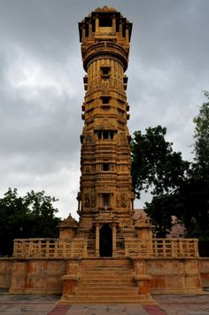 a tall tower sitting in the middle of a park