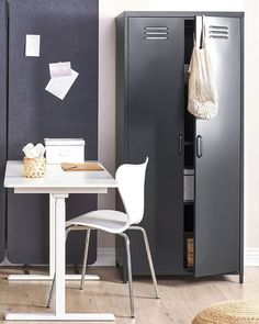 a room with a table, chair and locker