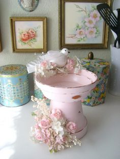 a pink bird bathtub with flowers on it