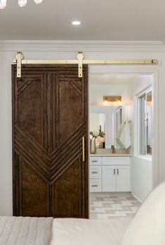 an open door leading to a bathroom and bedroom