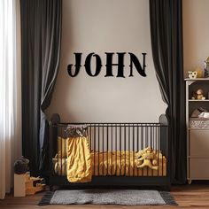 a child's room with a black and white name on the wall