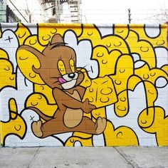 a large yellow and white wall with a cartoon bear painted on it