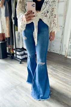 A pair of extreme flare jeans featuring a light distressed design, frayed raw hem, and ripped knee slits. These jeans offer two back patch pockets, faux front pockets, and a zip-fly closure.Rise: 11" Inseam: 34"Made In: Imported Fabric Contents: 73% Cotton, 14% Rayon, 11% Poly, 2% Spandex Fall Stretch Flares With Frayed Hem, Distressed Cutoff Flare Jeans For Fall, Distressed Wide Leg Flares For Fall, Casual Distressed Denim Flares, Distressed Wide-leg Flares For Fall, Dark Wash Flares With Frayed Hem For Fall, Ripped Cutoff Medium Wash Flare Jeans, Distressed Cutoff Flare Jeans, Fall Ripped Denim Flare Jeans