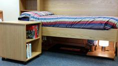 a bed with a book shelf underneath it