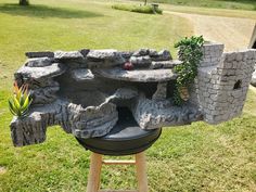 an outdoor grill made out of rocks and stones