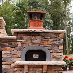 an outdoor fireplace with potted plants on top