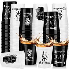 black and white cups with orange liquid splashing out of them, surrounded by skulls