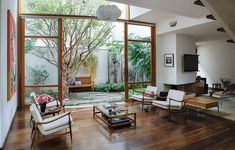 a living room filled with furniture and lots of windows