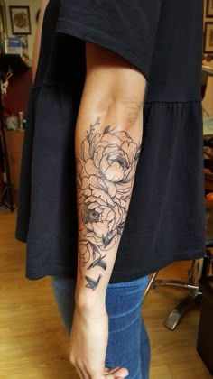 a person with a flower tattoo on their arm