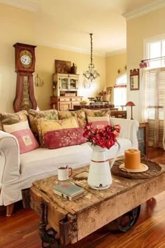 a living room filled with furniture and a coffee table in front of a clock on the wall