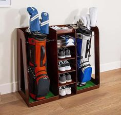 two wooden shelves with golf gear and bags on them in front of a white wall