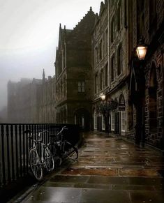 two bikes parked on the side of a street