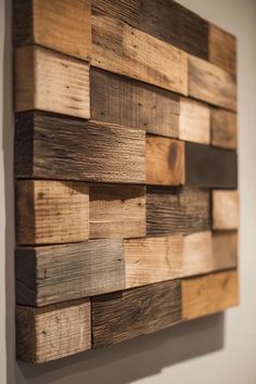 a wooden wall hanging on the side of a white wall with wood planks in it