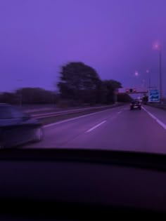 a car driving down the road at night