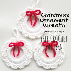 three crocheted ornaments with red bows on them