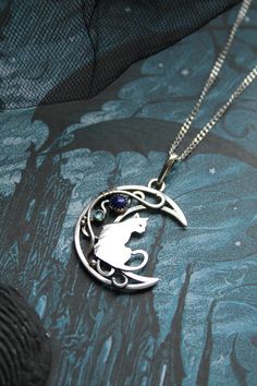 ITEM DESCRIPTION: The size of this moon pendant H 4 cm x W 3 cm. Weight - 4g. You can buy this necklace with a chain or without. Jewelry will come to you in a gift box - ready for gift giving. I made this moon phases necklace of sterling silver, Lapis lazuli, and topaz London. It looks like a real magic art. The handmade silver pendant with the cat will be a great gift for cat lovers. The parcel will be sent during 1-2 days after payment. Delivery usually takes 10-21 days. But in the period from Collectible Round Pendant With Moon Charm, Cat Design Round Pendant Jewelry Gift, Cat Design Pendant Jewelry, Collectible Moon Charm Pendant Necklace, Ursula Jewelry, Random Jewelry, Wire Animals, Cat And Moon, Moon Fashion