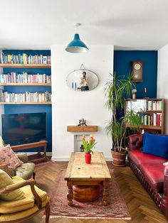 a living room filled with furniture and a flat screen tv mounted to the side of a wall