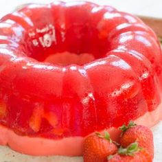 a bundt cake with strawberries on the side