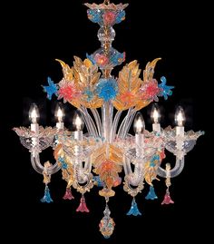 an ornate chandelier with many colorful flowers and leaves hanging from it's center