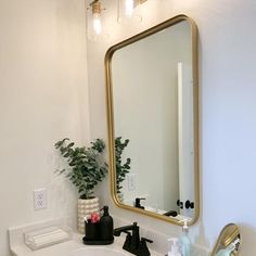 a bathroom sink sitting under a large mirror