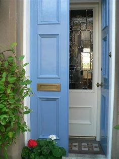 a blue front door is open to the outside