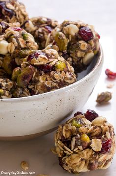 a bowl filled with granola and nuts on top of a table