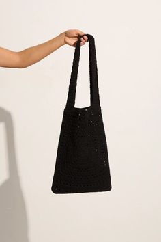 Lovingly handcrafted from 100% cotton using our signature in-house technique, the Piccolo Crochet Bag in Black features a relaxed tote shape, a fixed wide strap and an intricately woven square pattern. Designed to fit all of your sunshine essentials and carry you through summer moments with ease. The Piccolo was handmade in Bali, taking 2 days to carefully complete each piece. Black Woven Beach Bag With Double Handle, Black Square Cotton Bag, Black Woven Crochet Bag With Double Handle, Black Woven Bucket Bag With Double Handle, Black Handwoven Shoulder Bag With Double Handle, Black Square Crochet Bag For Shopping, Cotton Crochet Bag With Adjustable Strap, Black Rectangular Cotton Hobo Bag, Black Cotton Rectangular Hobo Bag