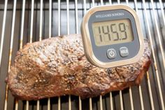 a meat thermometer sitting on top of a grill