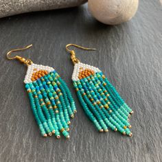 Inspired by the sunset over turquoise tropical seas, these earrings are lightweight and a celebration of the tropics. Perfect for those heading away on holidays or yearning for a little bit of sunshine and warmth. These would make a perfect birthday / Valentine / wedding gift for a mum, sister, friend, girlfriend, wife. Material: Japanese (Miyuki) and Czech beads woven using durable thread. Technique: Brick stitch and fringe Ear wire: You can choose between ear hooks and clip-on fittings. I offer a choice of finishes including sterling silver 925, gold-plated, golden and silver-colour fittings to suit most needs.   Dimensions: The length stated includes the handmade beaded piece and brass component. For the drop length, add 1.2 - 1.6 cm (ear wire-dependent)  Packaging: Earrings will be wra Cheap Beach Earrings With Tiny Beads, Turquoise Tassel Drop Earrings With Colorful Beads, Turquoise Tassel Earrings With Colorful Beads, Turquoise Tassel Earrings With Colorful Beads For Festival, Festival Turquoise Tassel Earrings With Colorful Beads, Turquoise Earrings With Beaded Fringe For Beach, Turquoise Beaded Beach Earrings, Turquoise Beaded Tassel Earrings For Festival, Turquoise Beaded Fringe Earrings For Summer