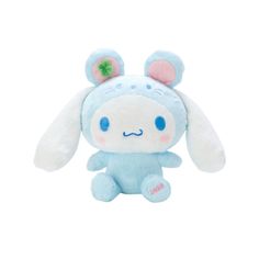 a small stuffed animal with blue eyes and ears on it's head, sitting in front of a white background