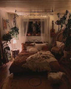 a bed with lots of pillows on top of it in a room filled with plants