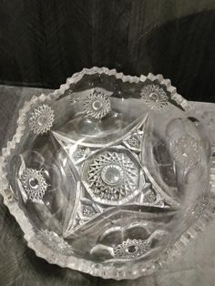 an ornate glass bowl on a table