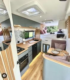 the interior of an rv with wood flooring and white walls is shown in this image