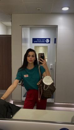 a woman taking a selfie in an airport