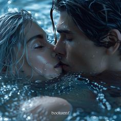 a man and woman are kissing in the water while they're surrounded by bubbles