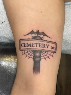 a tattoo on the leg of a woman that reads cemetery dr