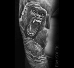 a man's arm with a gorilla on it and an angry face in the background