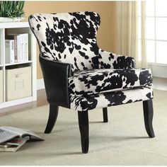 a black and white chair sitting in front of a book shelf