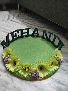 a green tray with flowers and the word meeshad written in cursive letters