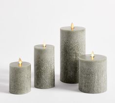 three grey candles sitting next to each other