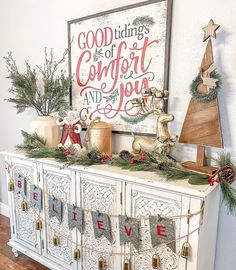 an old dresser decorated with christmas decorations