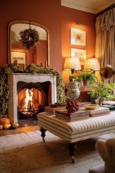 a living room filled with furniture and a fire place next to a mirror on the wall