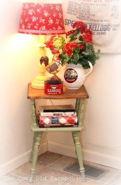 a small table with books and a lamp on it