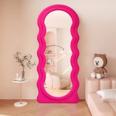 a pink mirror sitting in the middle of a living room next to a white couch