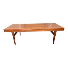 a wooden table with two leaves on the top