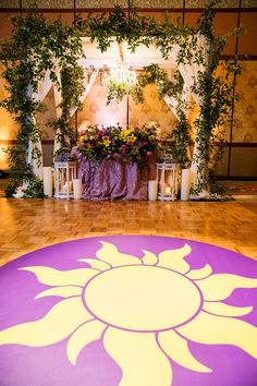 the floor is decorated with flowers, candles and greenery for an outdoor wedding ceremony